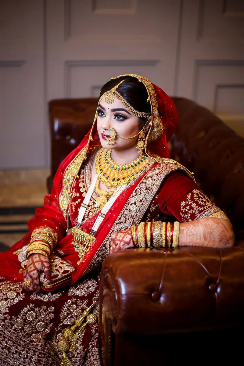 A bride in red wearing gold jewellery