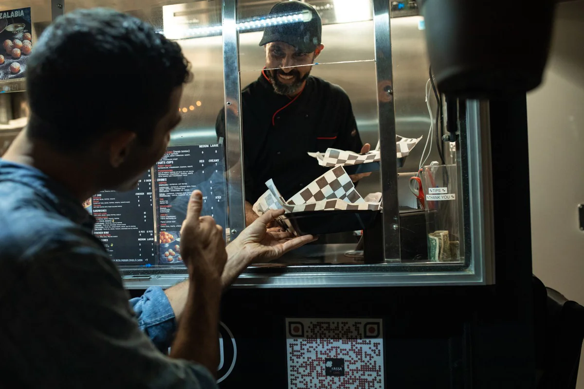 A customer paying at a shop counter