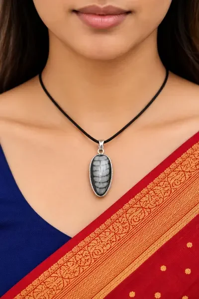 Natural Orthoceras fossil pendant necklace worn as a statement spiritual jewellery piece