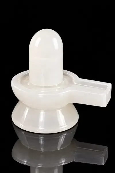 Original Sphatik Shivling with smooth white crystal finish displayed against a deep blue background.