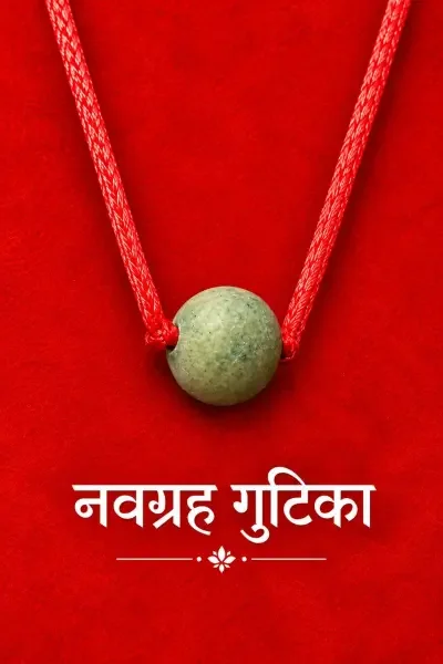 Navagraha Gutika 20 Gram shown on a rich red fabric background, highlighting the natural-looking green spherical Gutika and traditional red sacred thread.