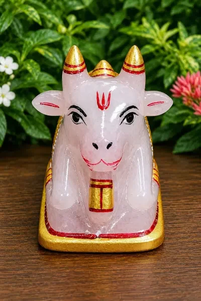 Coloured Sphatik Nandi Ji displayed on a wooden surface, highlighting its crystal texture, traditional artwork and gold detailing.