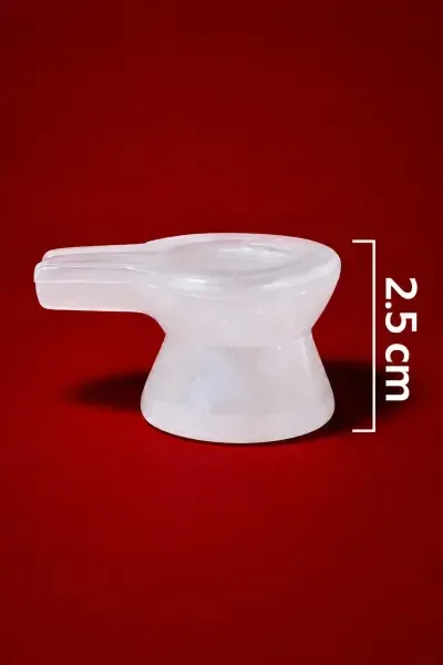 Side view of the Natural Sphatik Vedi, showcasing its smooth translucent white appearance, traditional Shivling base design and 2.5 cm height.
