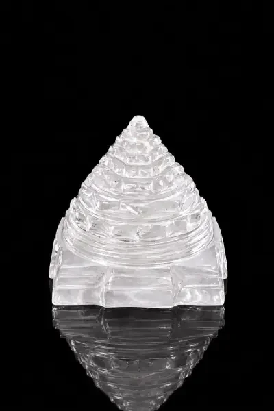 Clear Sphatik Shree Yantra with layered geometric design, photographed against a black background to highlight its crystal clarity and polished finish.