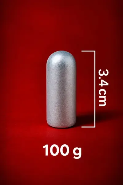 Close-up view of the 100 Gram Astha Sanskarit Parad Shivling, showing its smooth cylindrical form and 3.4 cm / 34 mm height.