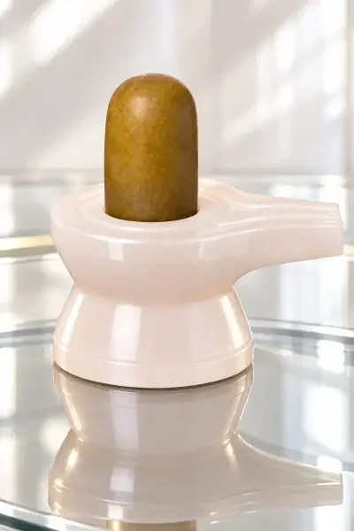 NavaPashanam Shivling 50gm with Damru Vedi, displayed on a glossy surface highlighting its detailed texture and design.