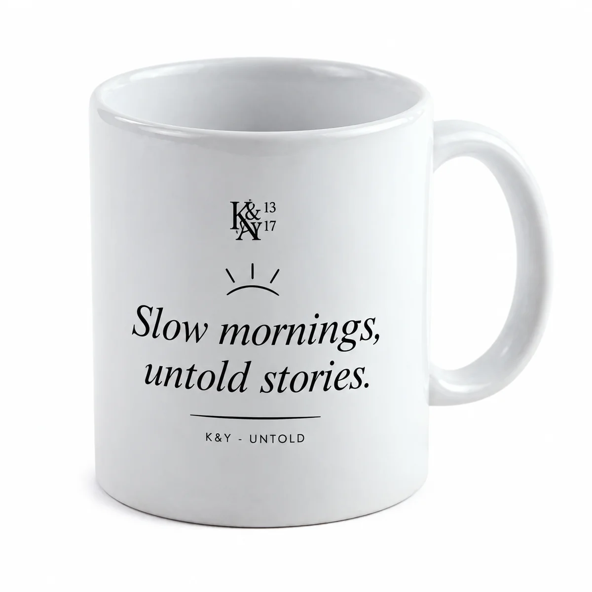 Digital product mockup of a white ceramic mug with Slow mornings, untold stories in black, a delicate sunrise and a small K&Y monogram, based on the supplier mu