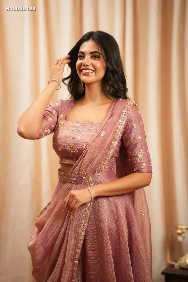 Rk ethinics.. Draped in dusty rose, this lehenga radiates refined glamour. Shimmering beadwork adds graceful sparkle to every movement. Flowing volume creates a regal 2