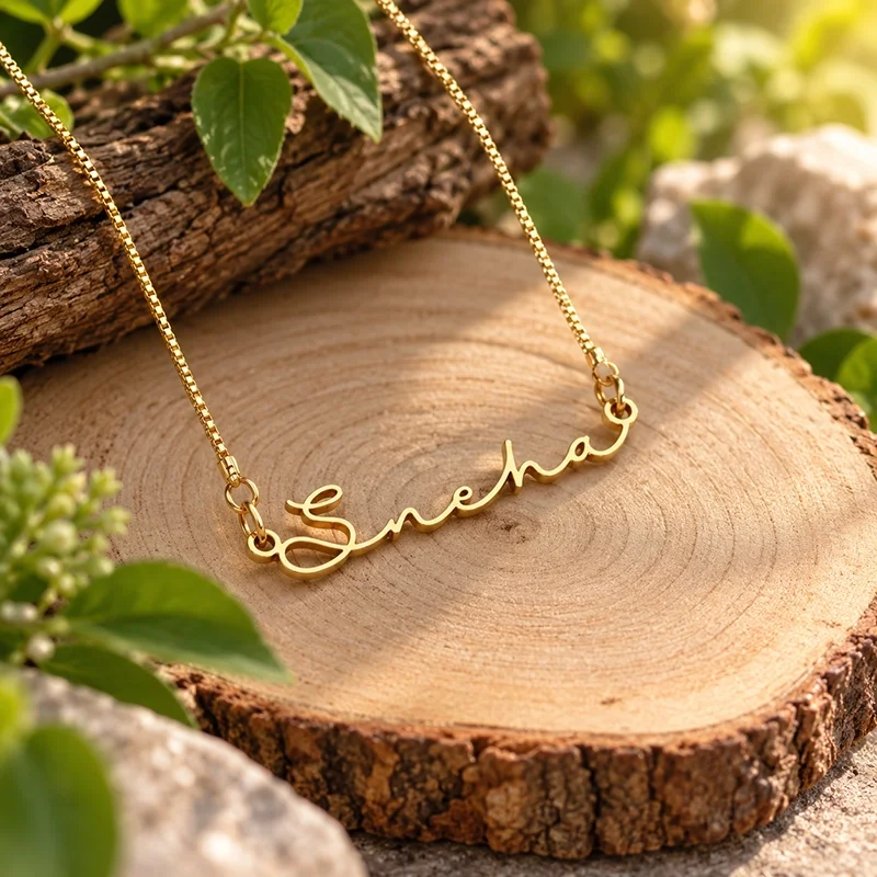 Gold Plated Signature Style Name Necklace with Sneha cursive pendant on wooden background by IGIFTZI.